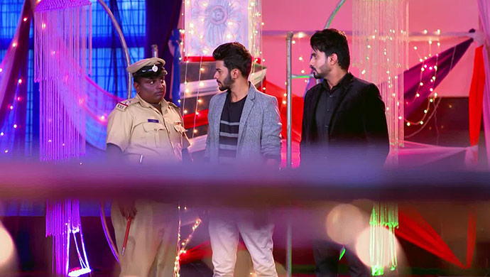 A Still Of The Police Inspector Looking At Vicky And Vedanth