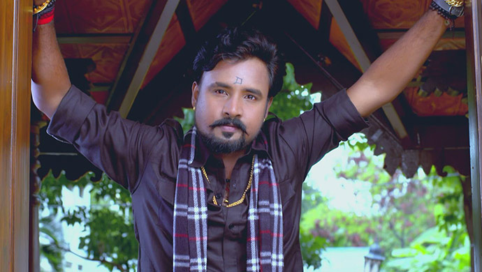 A Still Of Vajramuni Outside Radha's House