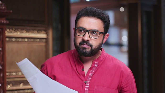 A Still Of Chandru Holding The Power Of Attorney Papers